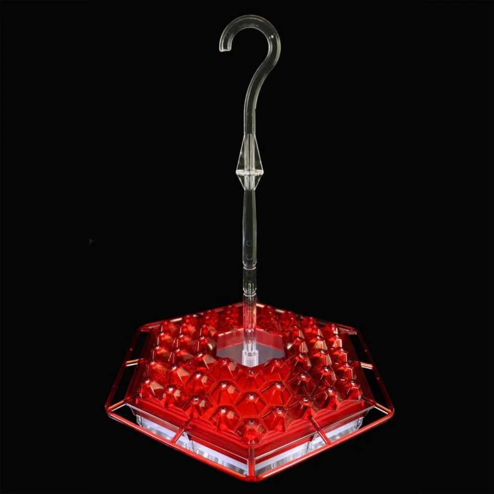 A red umbrella feeder with a light on top.
