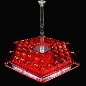 A red light fixture with a clear base.