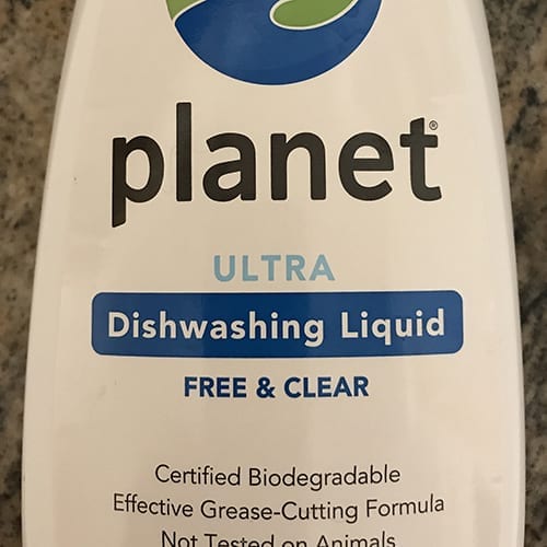 A bottle of planet ultra dishwashing liquid.