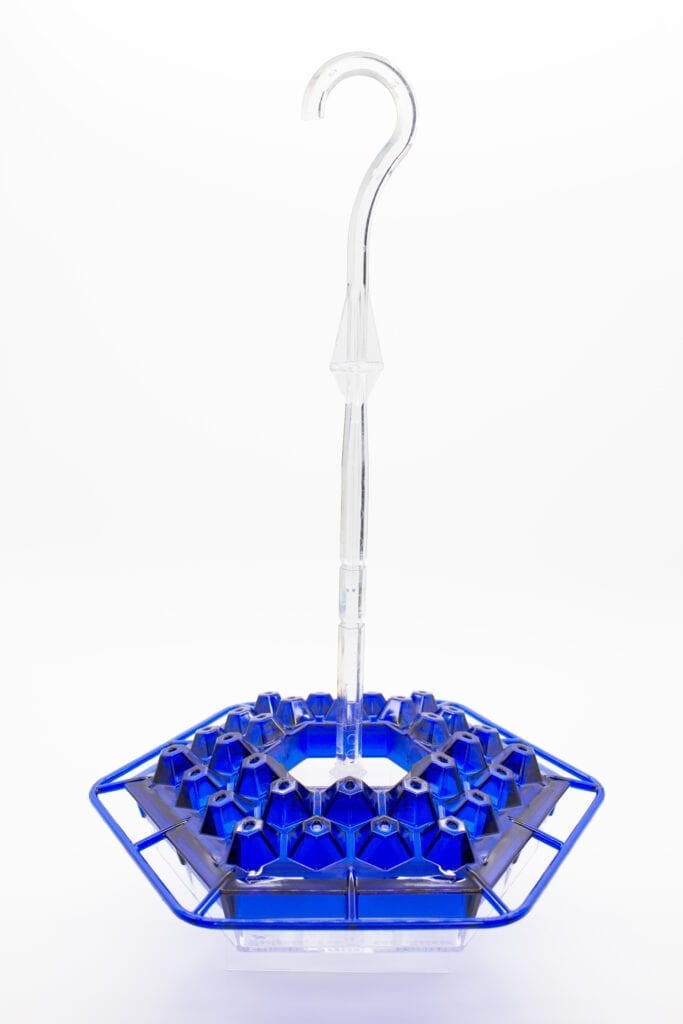 A blue plastic bottle holder with a white handle.