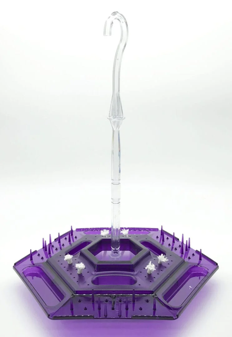A purple and black plastic stand with a clear base.