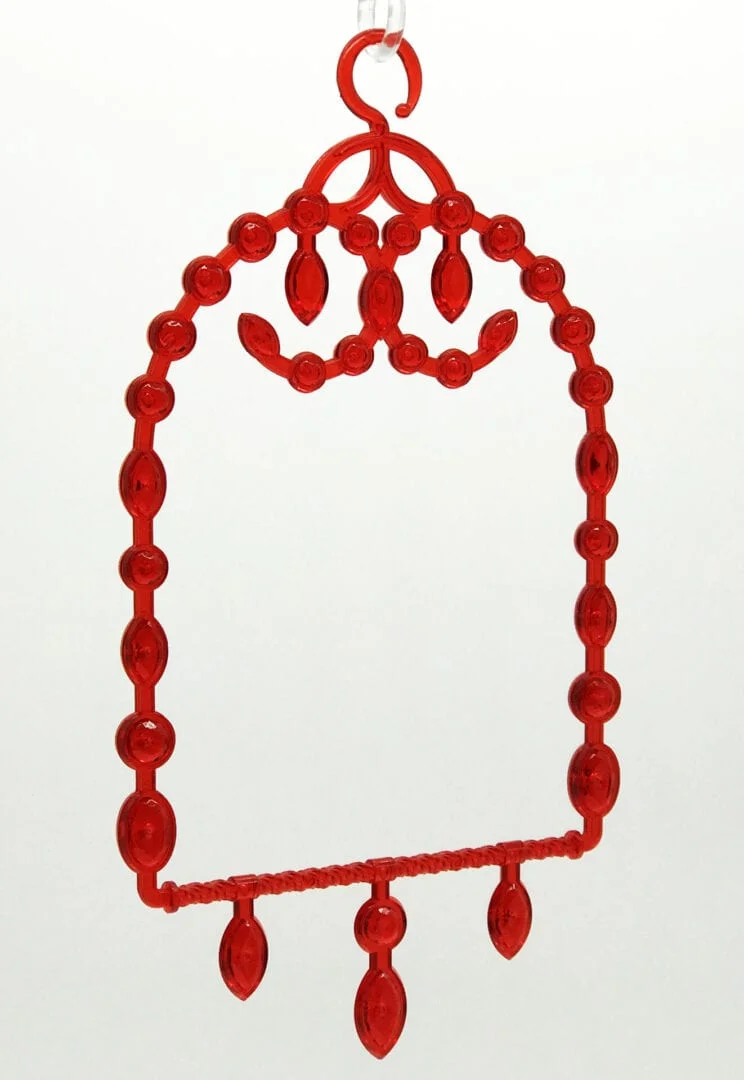 A red plastic frame with a large beaded design.