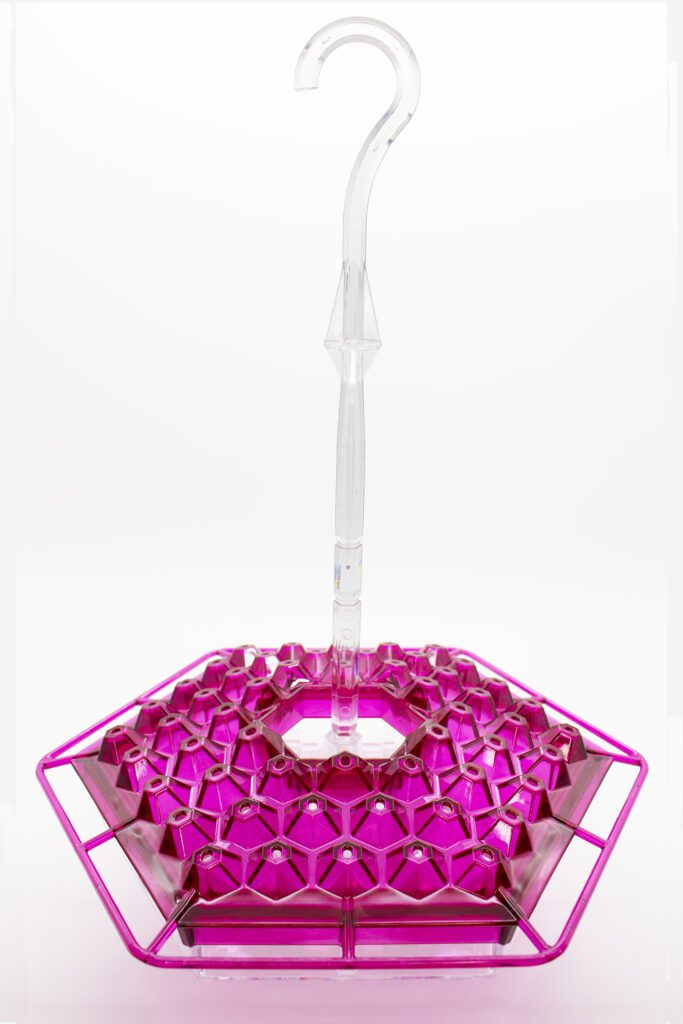 A pink lamp with a clear base and a purple light